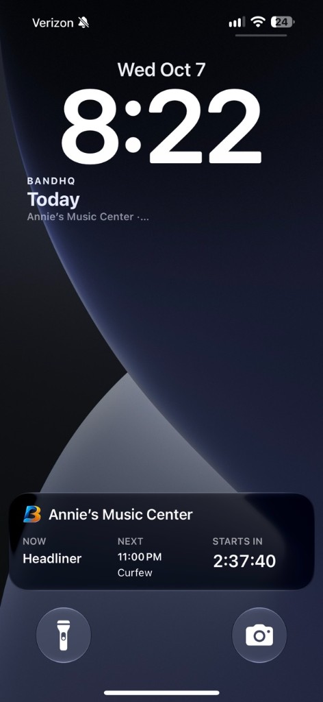 iPhone Lock Screen showing BandHQ Next show widget under the clock and a live countdown card for Annie’s Music Center
