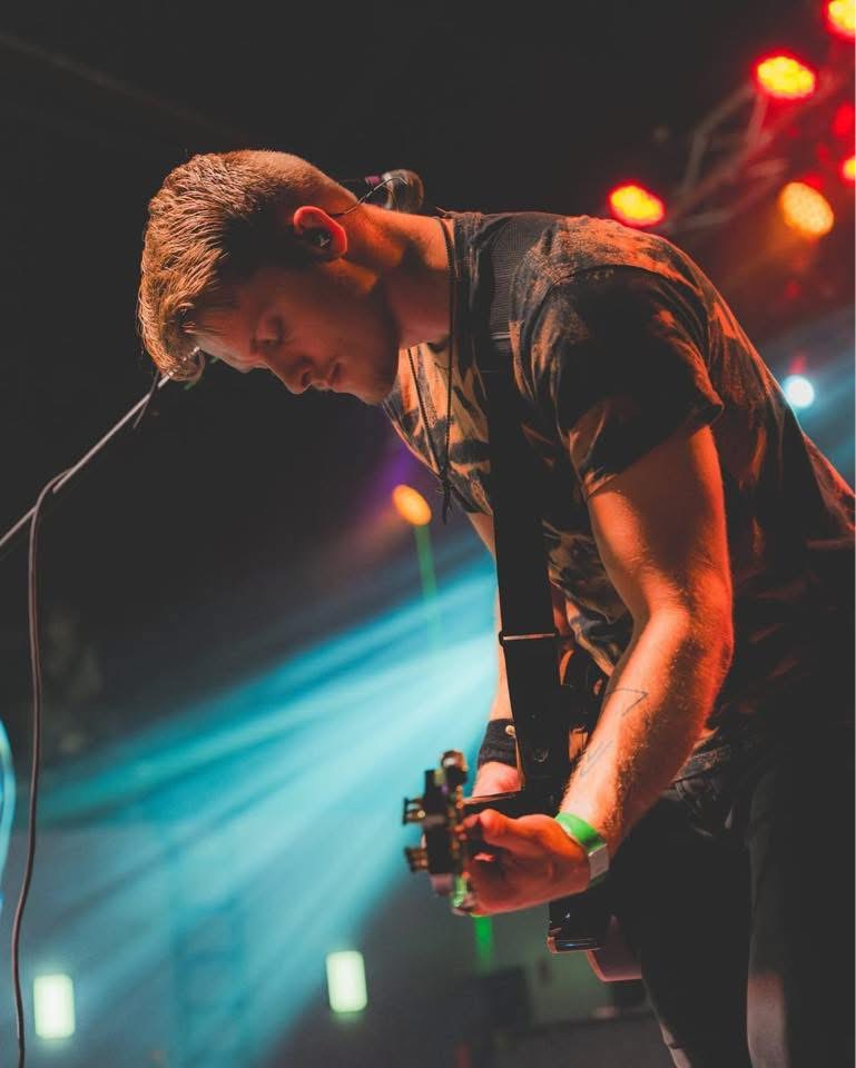 Josiah Wilder performing live on guitar